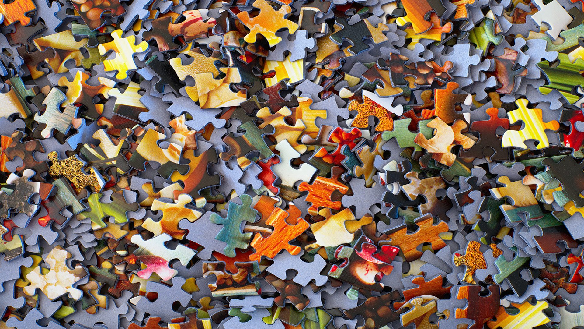 Close-up of scattered jigsaw puzzle pieces.