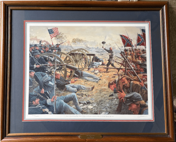 Framed painting of a Civil War battle scene with cannons and soldiers.