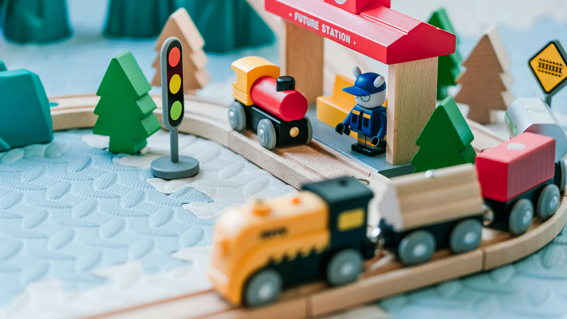 A wooden toy train set with a "Future Station" stop.