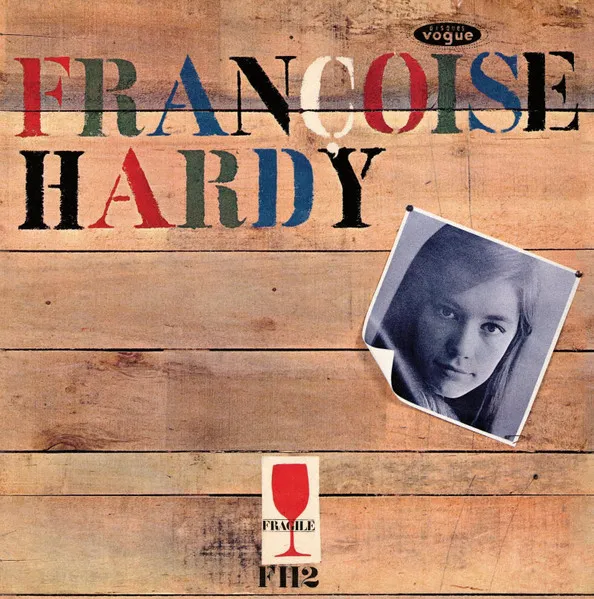 Françoise Hardy album cover: multicolored stencil name on wooden planks, with her B&W photo.