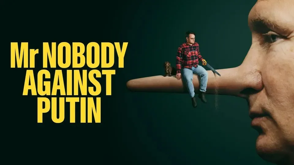 Mr NOBODY AGAINST PUTIN poster. A small man and a dog sit on a giant Pinocchio nose on the face of Putin as the man saws it.