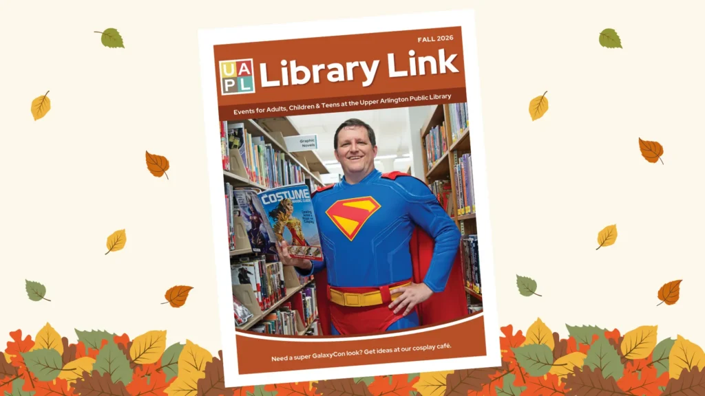 A man dressed as Superman reading a costume guide in a library, framed by autumn leaves.