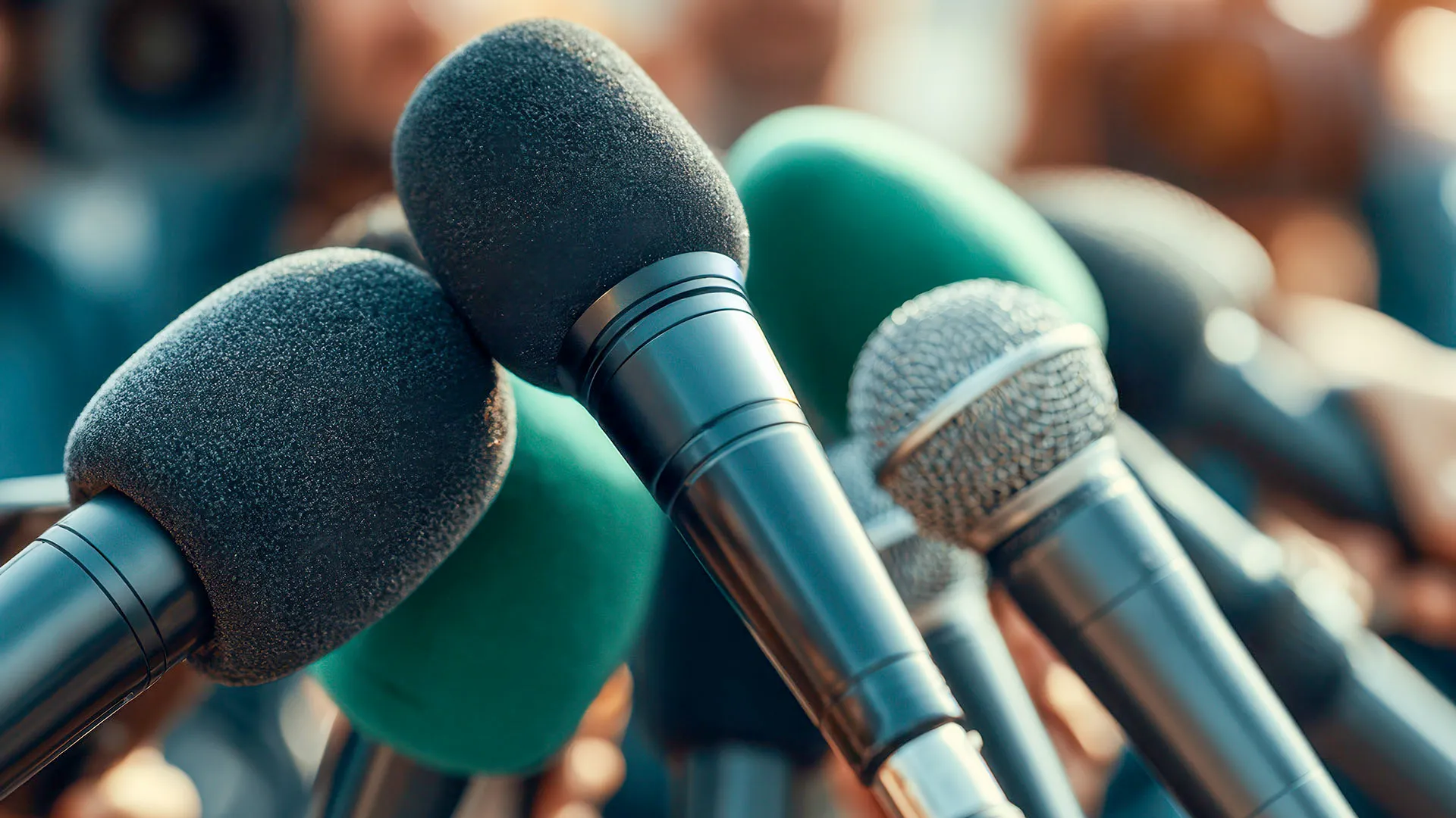 A close-up of multiple microphones held together for an interview.